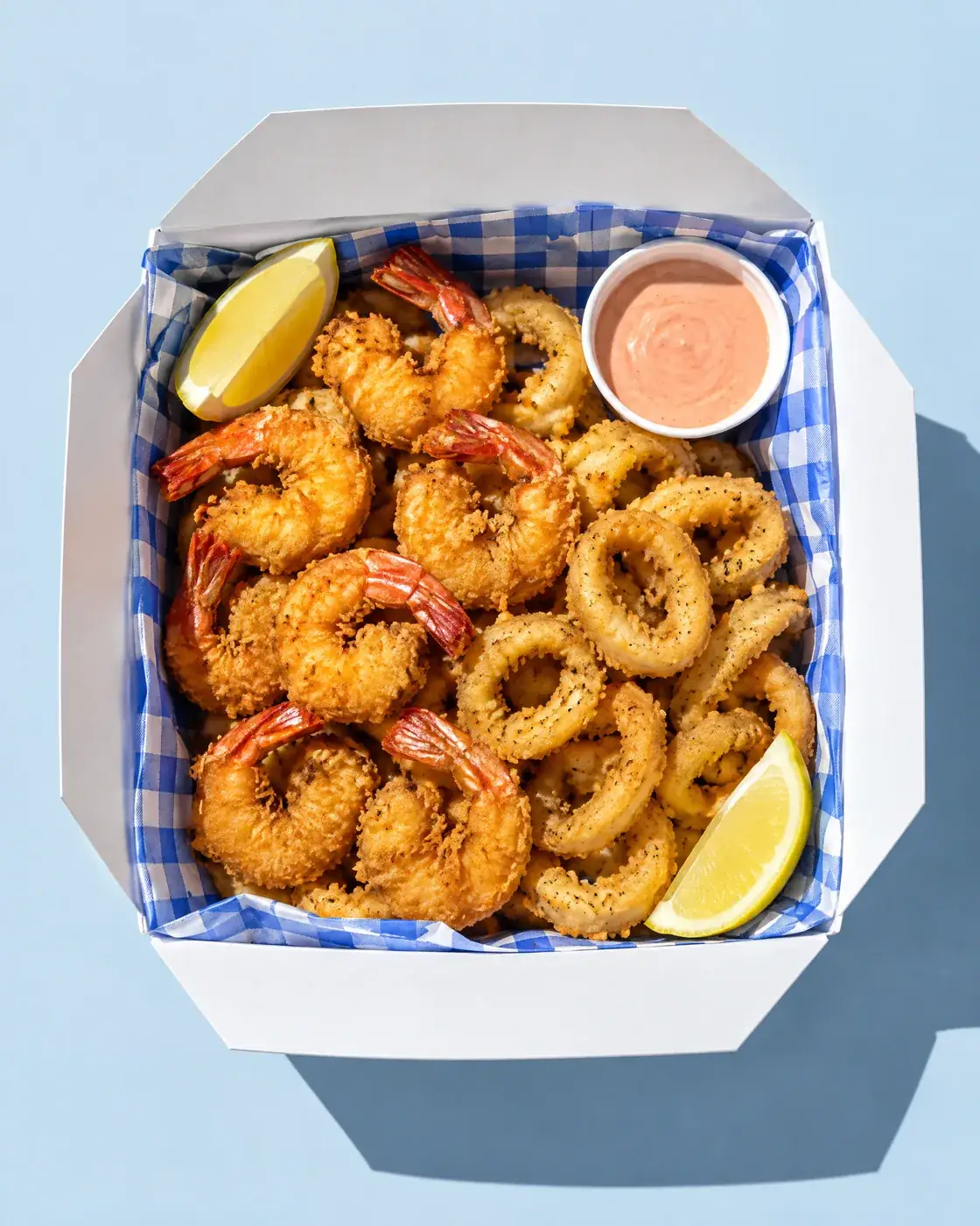 Box of crispy shrimp and calamari seen from above